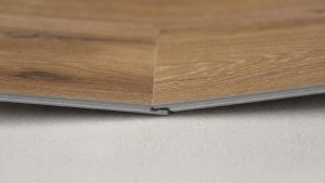 Close-up of types of LVP locking systems showing the click-lock joint between two luxury vinyl planks